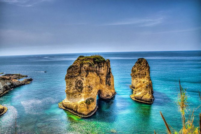 Private Beirut City Tour with Boat Ride at Raouche Rock - A boat under the Pigeon Rocks at Raouche